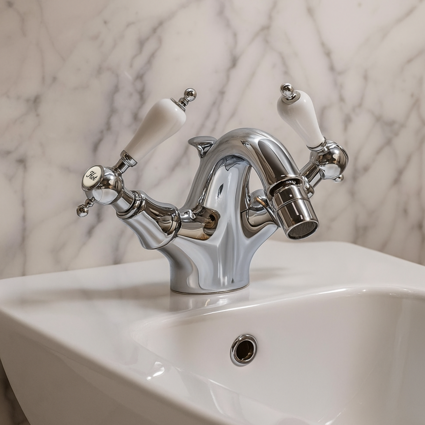 Chrome bathroom faucet with white handles on a marble wall background