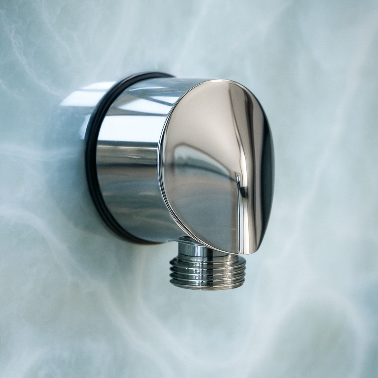 Chrome shower head on a marble wall