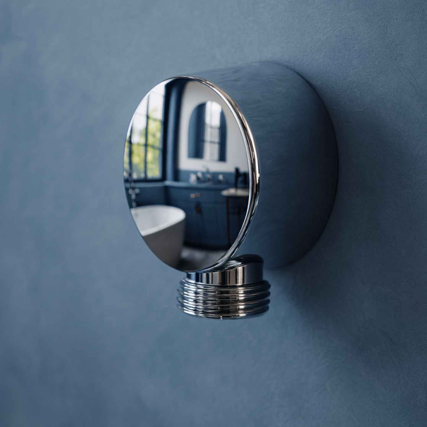Round chrome mirror on a blue wall