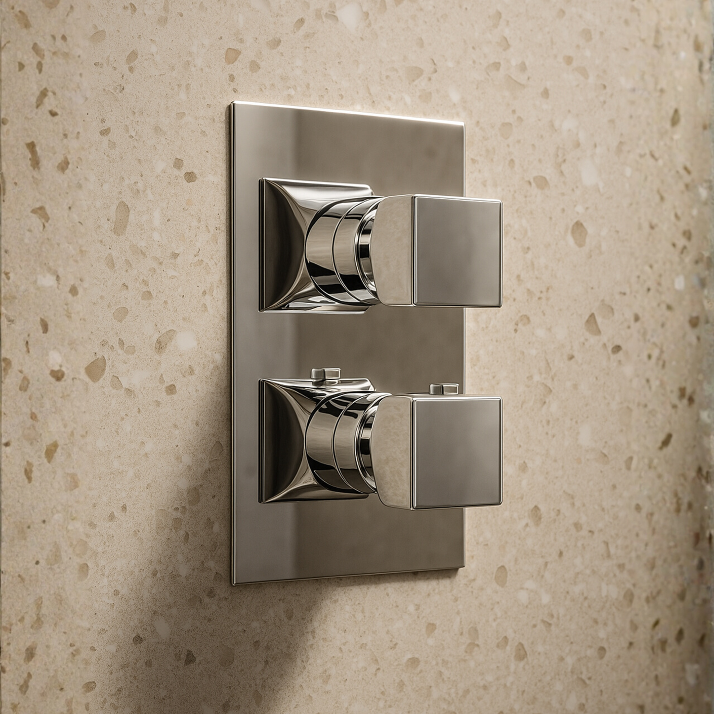 Chrome wall-mounted control panel on a beige textured wall