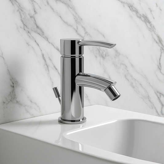 Chrome faucet on a white sink with a marble wall background