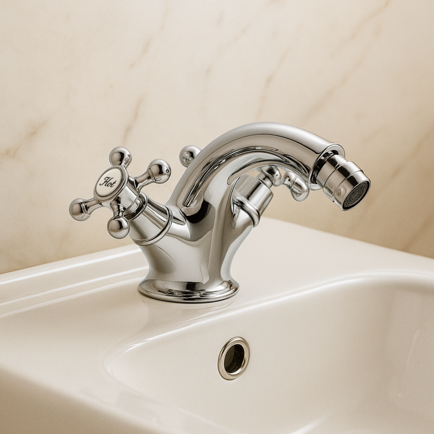 Chrome bathroom faucet on a sink with a beige wall background