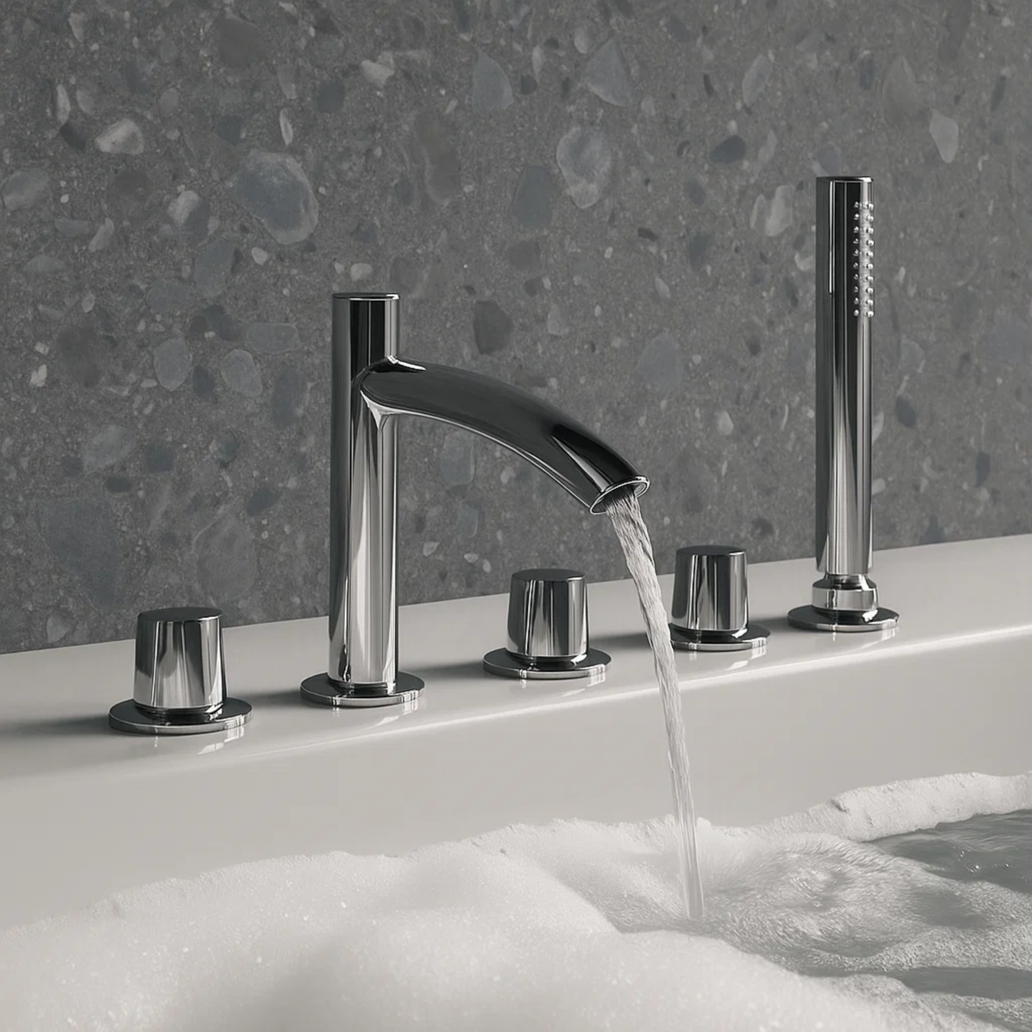 Chrome bathtub faucet set with running water on a bathtub filled with bubbles against a gray stone wall.