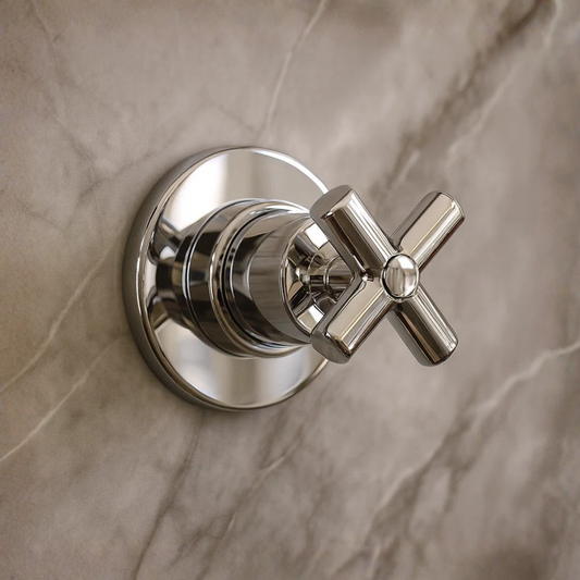 Chrome bathroom valve on a marble wall