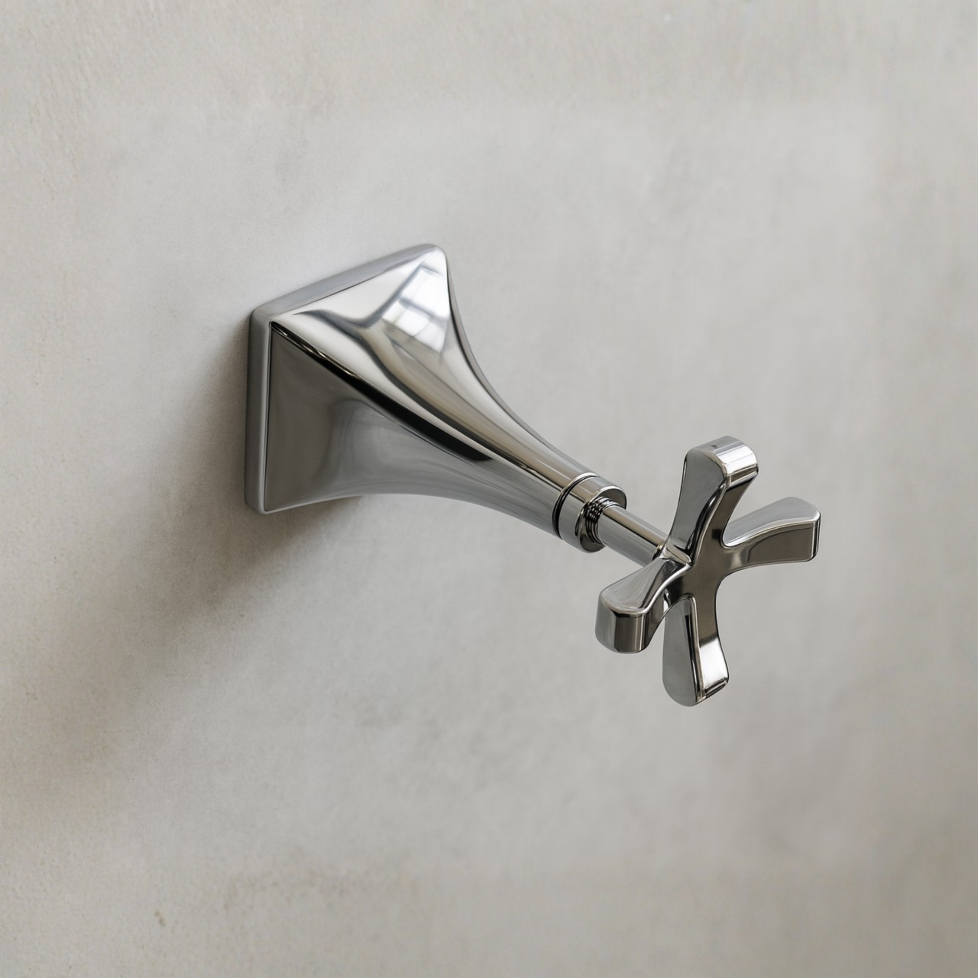 Chrome wall-mounted shower head on a light gray background