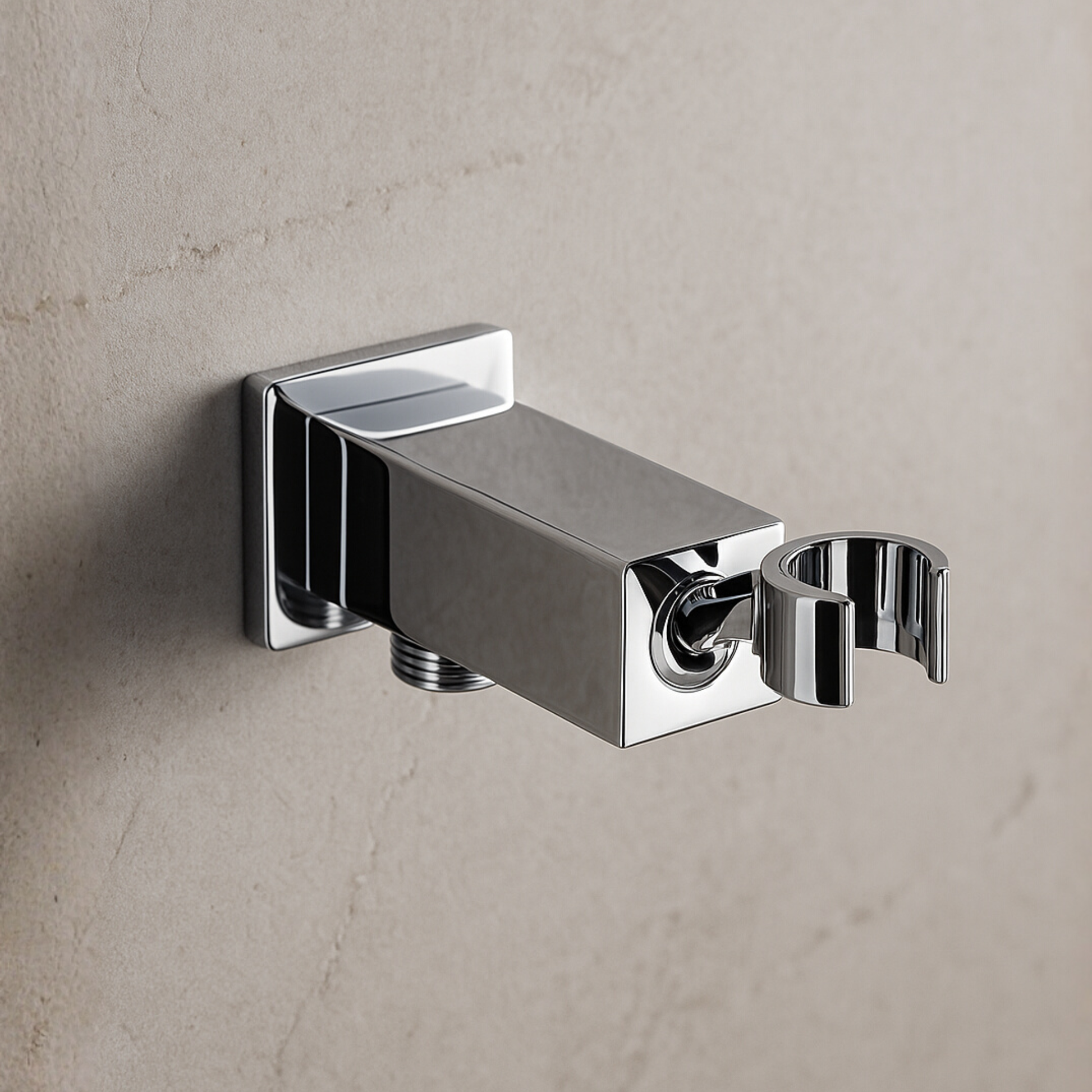 Chrome wall-mounted shower arm on a gray concrete wall