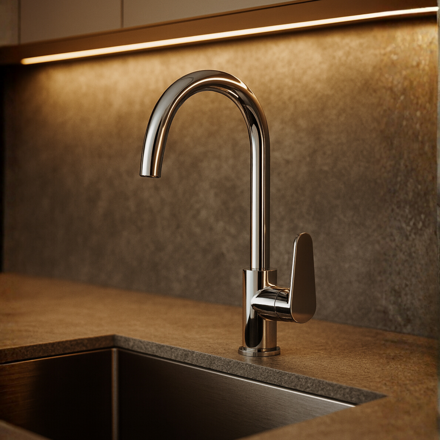 Modern kitchen faucet on a countertop with a warm-toned backsplash.