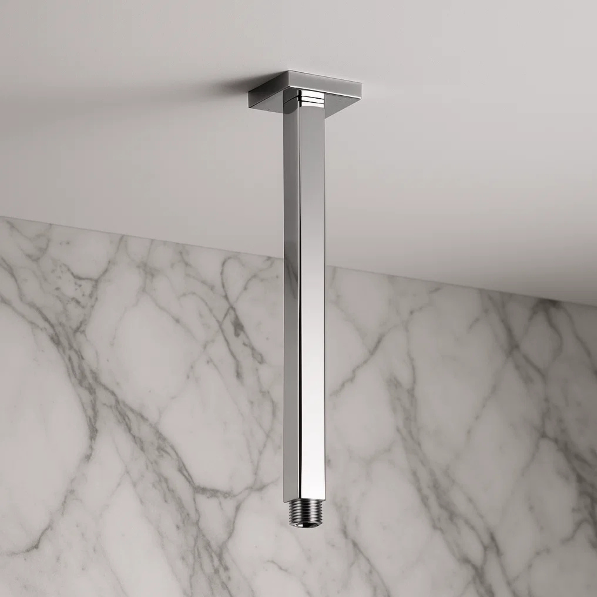 Chrome ceiling-mounted shower head on a marble wall background