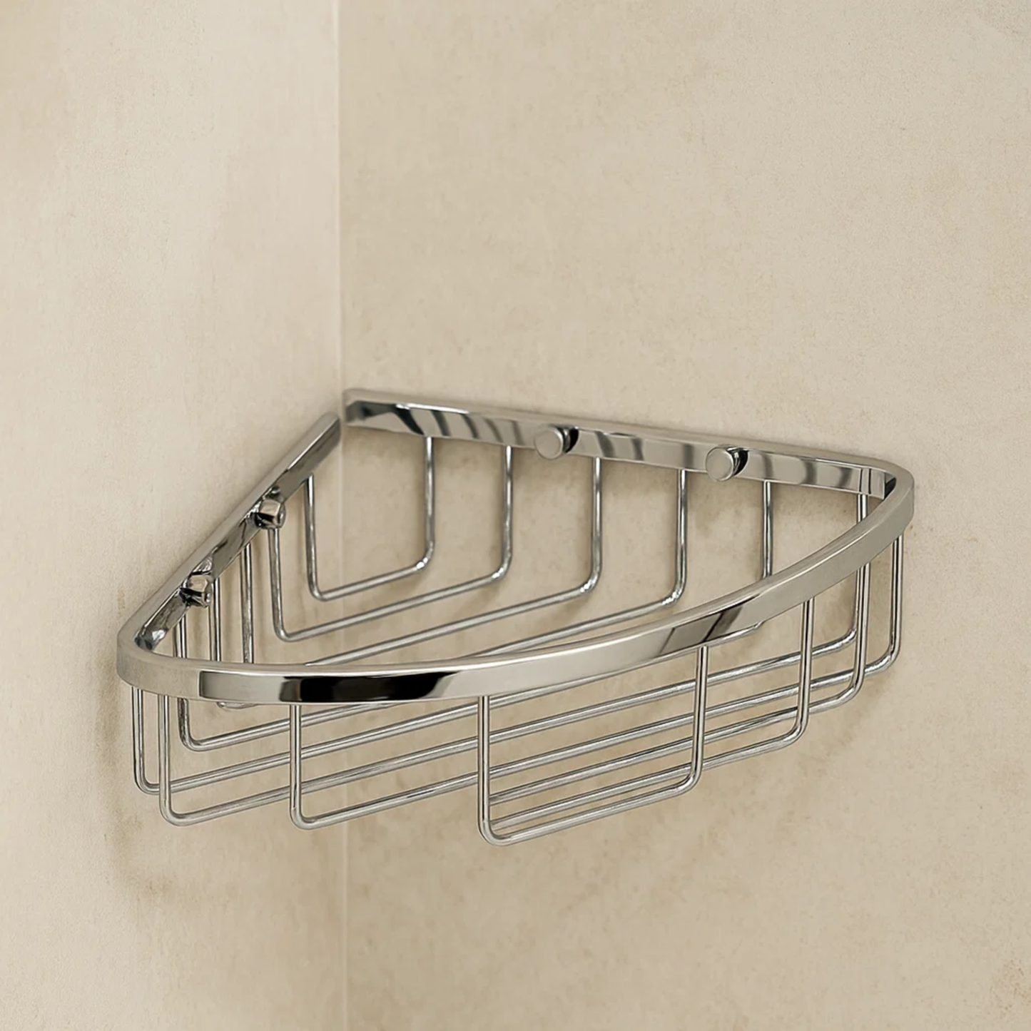 Chrome corner shower caddy mounted on a beige tiled wall