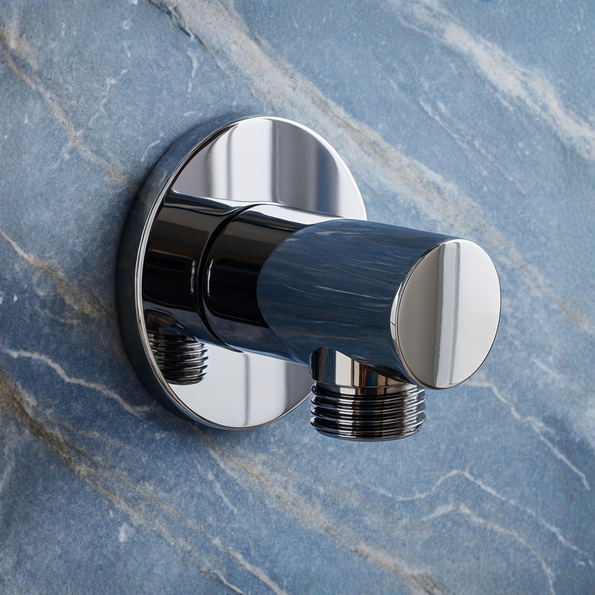 Chrome bath valve on a marble wall