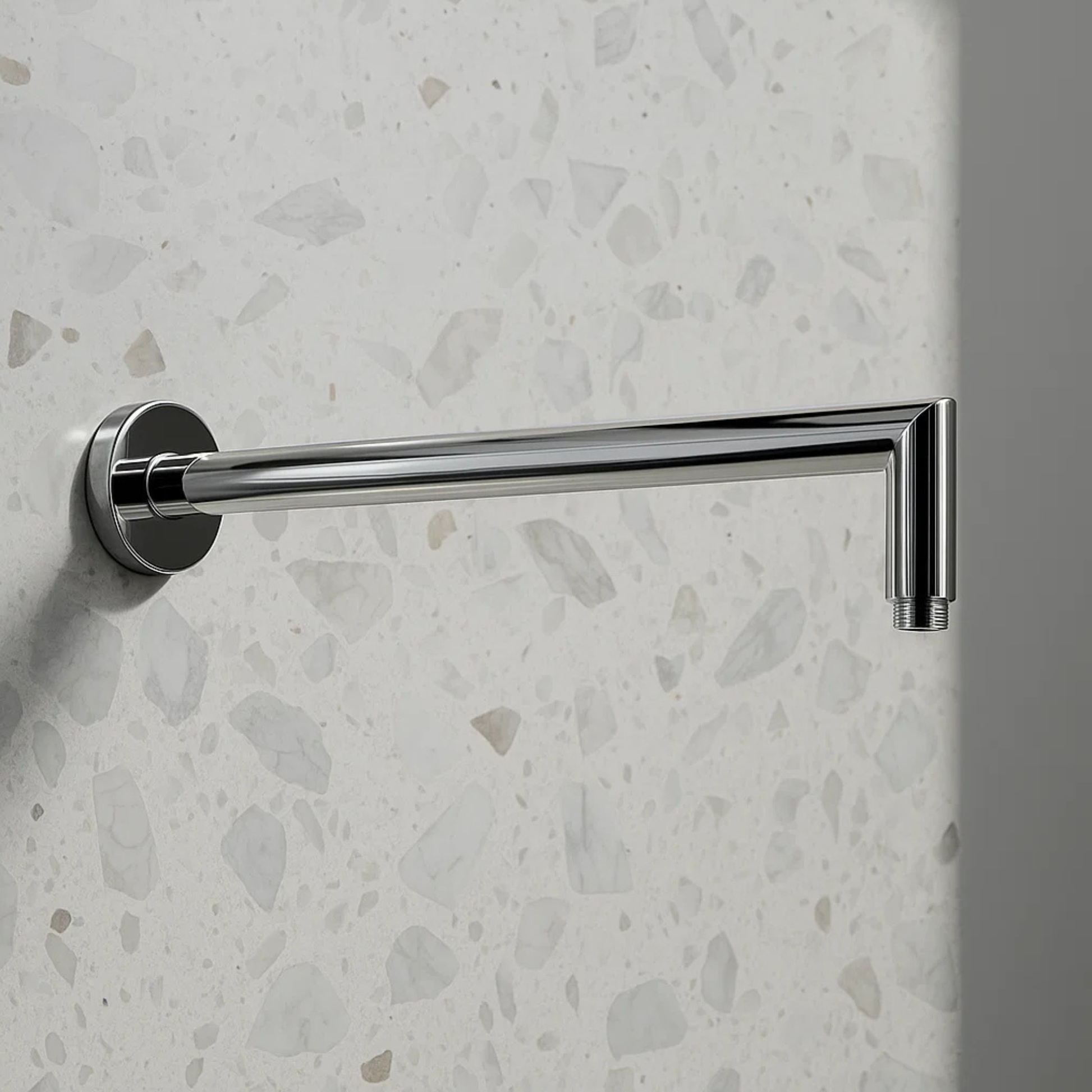 Chrome towel bar mounted on a textured wall