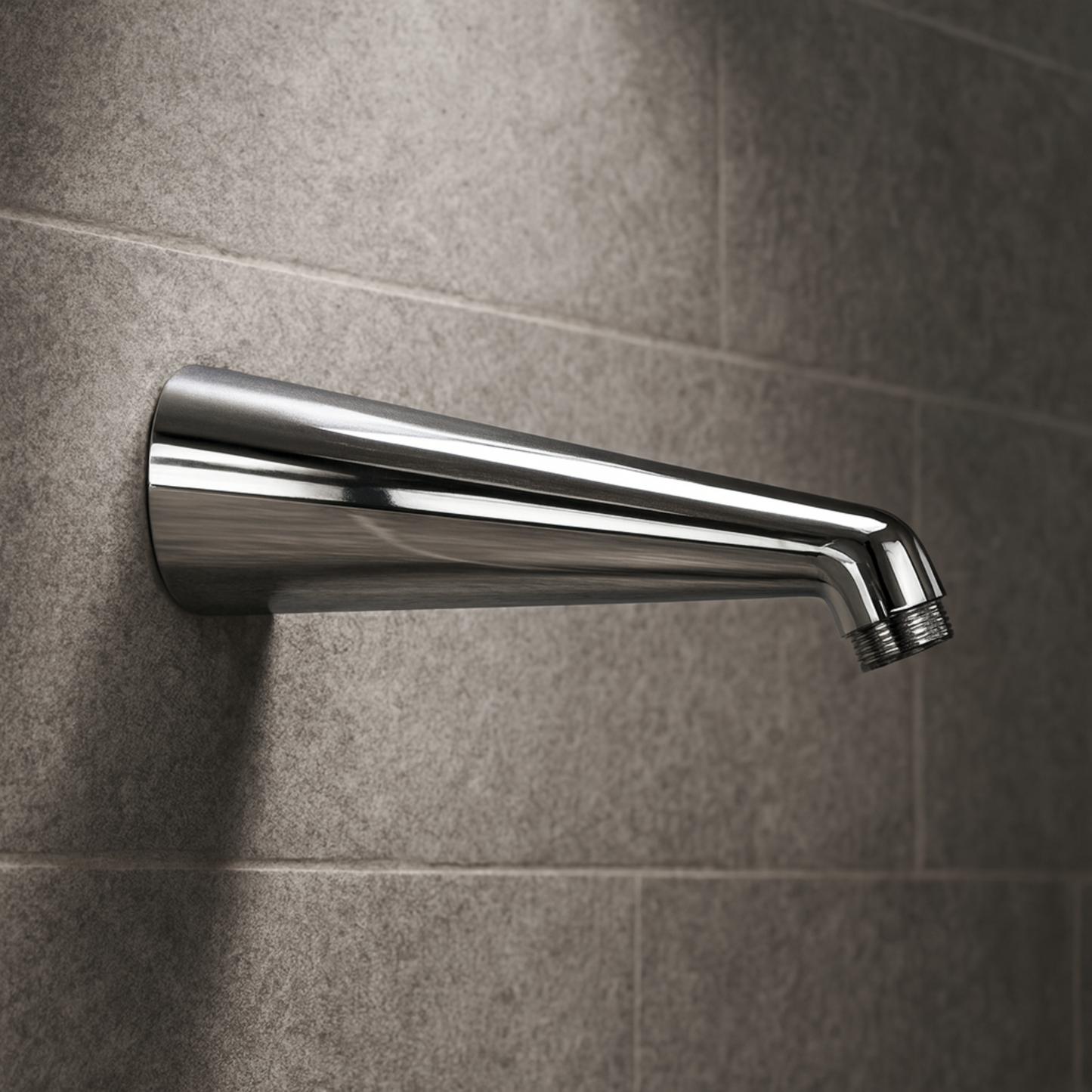 Chrome shower head mounted on a tiled wall
