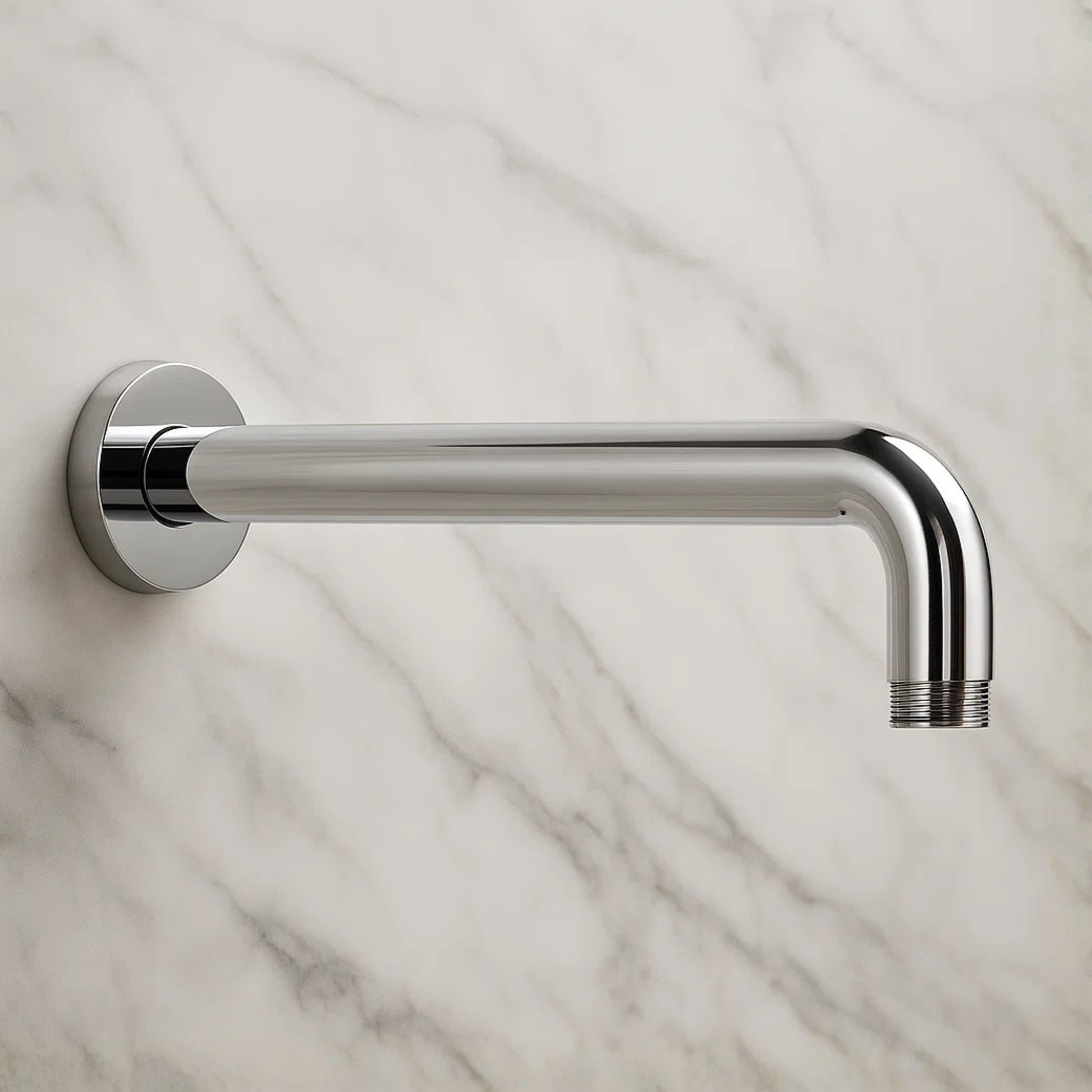 Chrome shower arm mounted on a marble wall