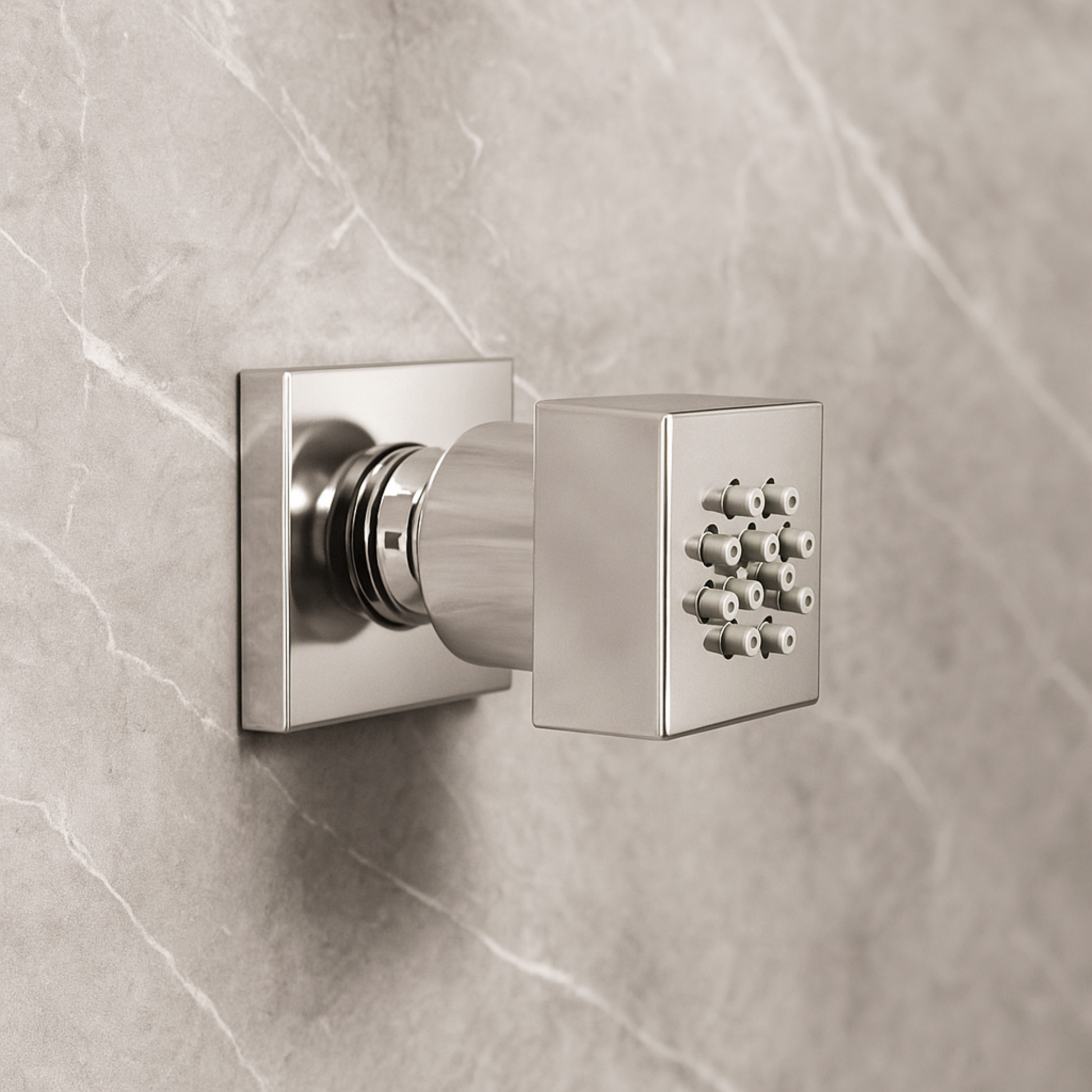 Metallic shower control valve on a tiled wall