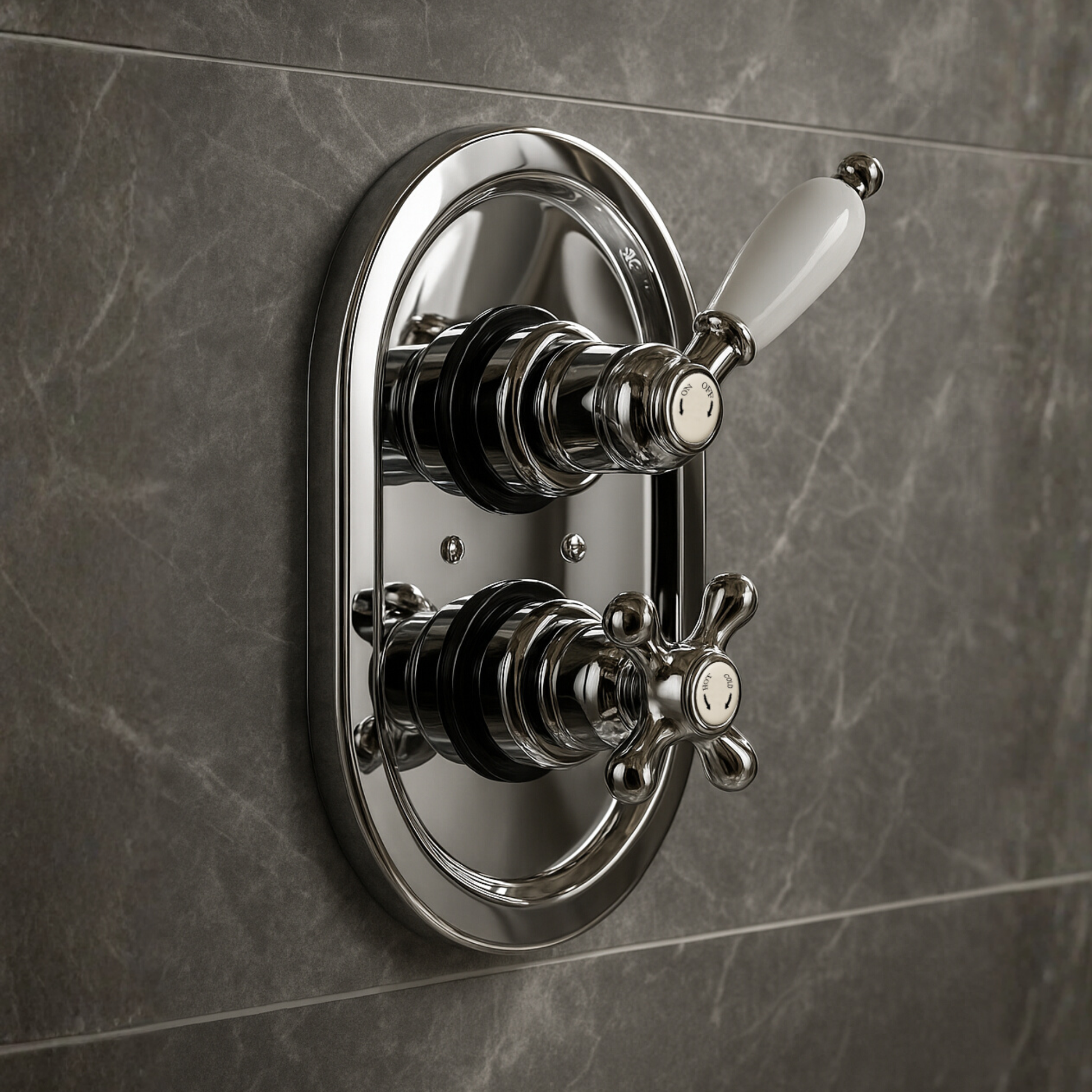 Chrome bathroom valve with two handles on a gray tiled wall