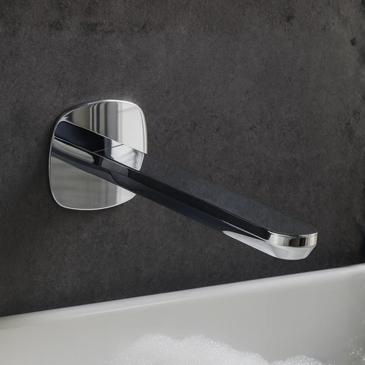 Chrome wall-mounted faucet handle on a dark tiled wall